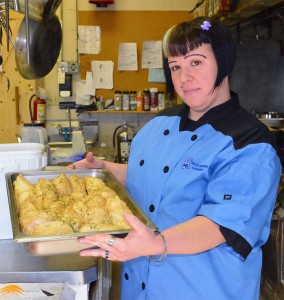 Blue Rubbon Catering cook Amanda Ungerer displays the usiness' best selling dish, their honey wine chicken.